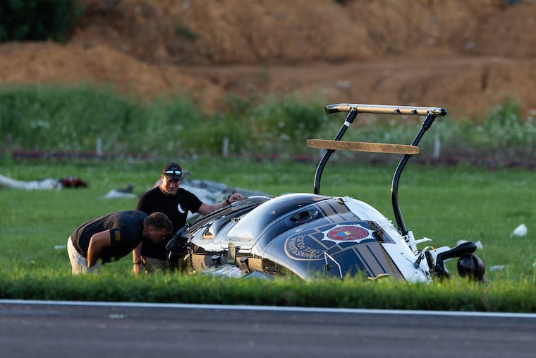 Authorities investigate a crash between a Pennsylvania State Police helicopter and a small plane at the Carlisle airport in Carlisle.