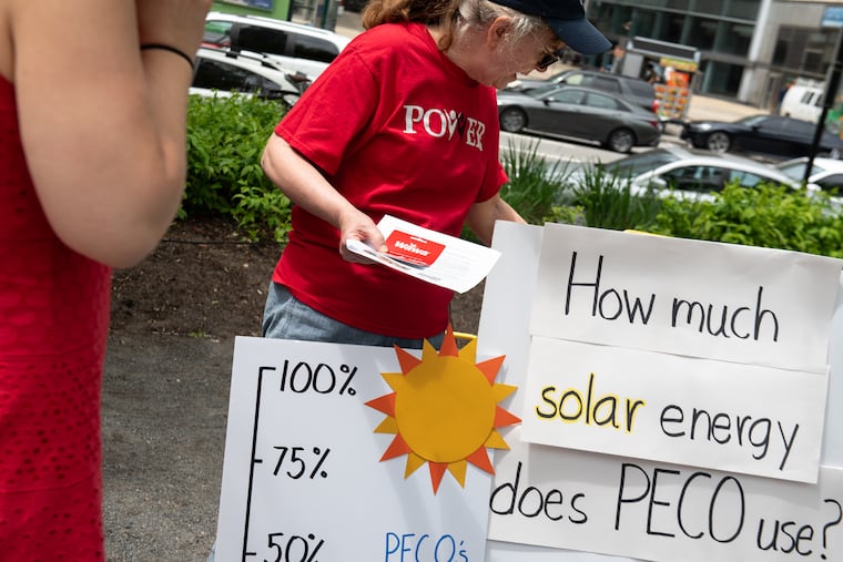 Volunteer Wendy Greenspan (center) hands out stickers and Wawa gift cards to participants during an engagement activity hosted by POWER Interfaith, a religious advocacy organization, to educate members of the public about their plans to encourage Peco to increase its use of renewable energy outside of City Hall on Wednesday, May 8, 2024. POWER Interfaith is one of the groups that testified at the Pennsylvania Public Utilities Commission hearings in April 2024, which will help decide how Peco procures its energy supply.