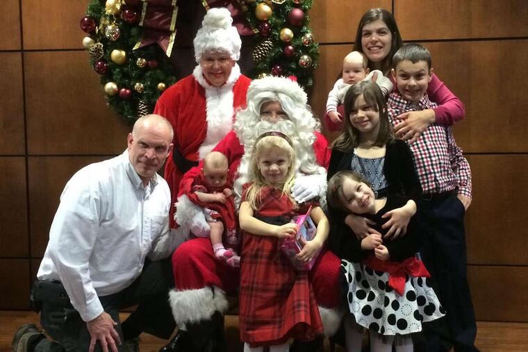 The Kochanowicz family, clockwise from top, Michelle (holding Andrew), Nicholas, Isabella, Amelia, Alyssa, Lily, and Mark.