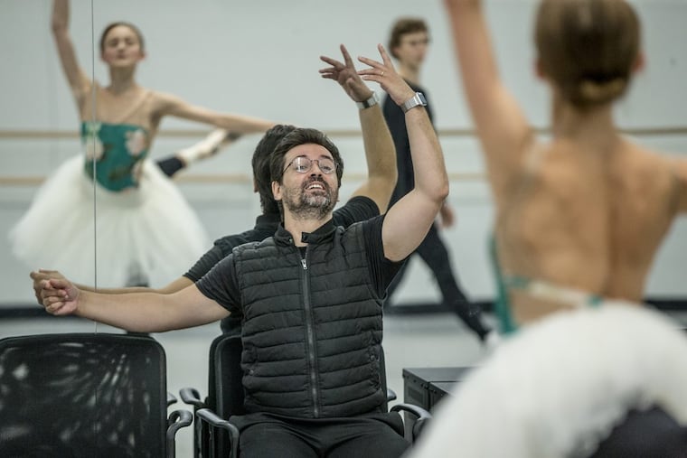 Pennsylvania Ballet artistic director Angel Corella (seated) works with principal dancer Oksana Maslova (right and reflected in the mirror) as they rehearse “The Sleeping Beauty,” which opens the season Thursday.