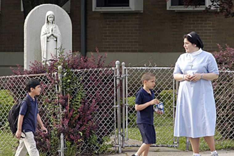 Holy Innocents Catholic School 8th grade teacher Sister Danielle Therese informs students arriving at the school today that classes were canceled after a double shooting in the parking lot. (Tom Gralish / Inquirer)