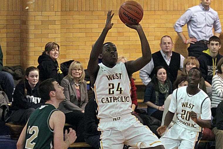 West Catholic's Jahmil Harris shoots over Lansdale Catholic's Brian Rafferty. (Yong Kim/Staff Photographer)