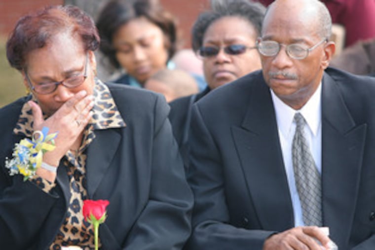 Priscilla and Robert Porter, parents of Officer Robert "Petey" Porter, attend yesterday's plaque-dedication ceremony in front of First District Plaza, 38th and Market, where he died.