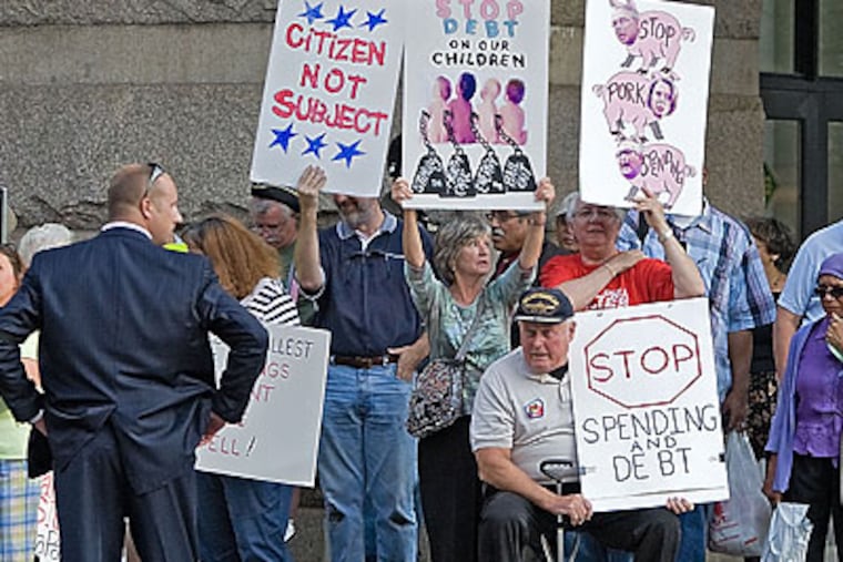 Hundreds of protesters demonstrated outside the Convention Center as President Obama spoke inside at a fundraiser for Sen. Arlen Specter's re-election campaign. (David M Warren/Staff Photographer)