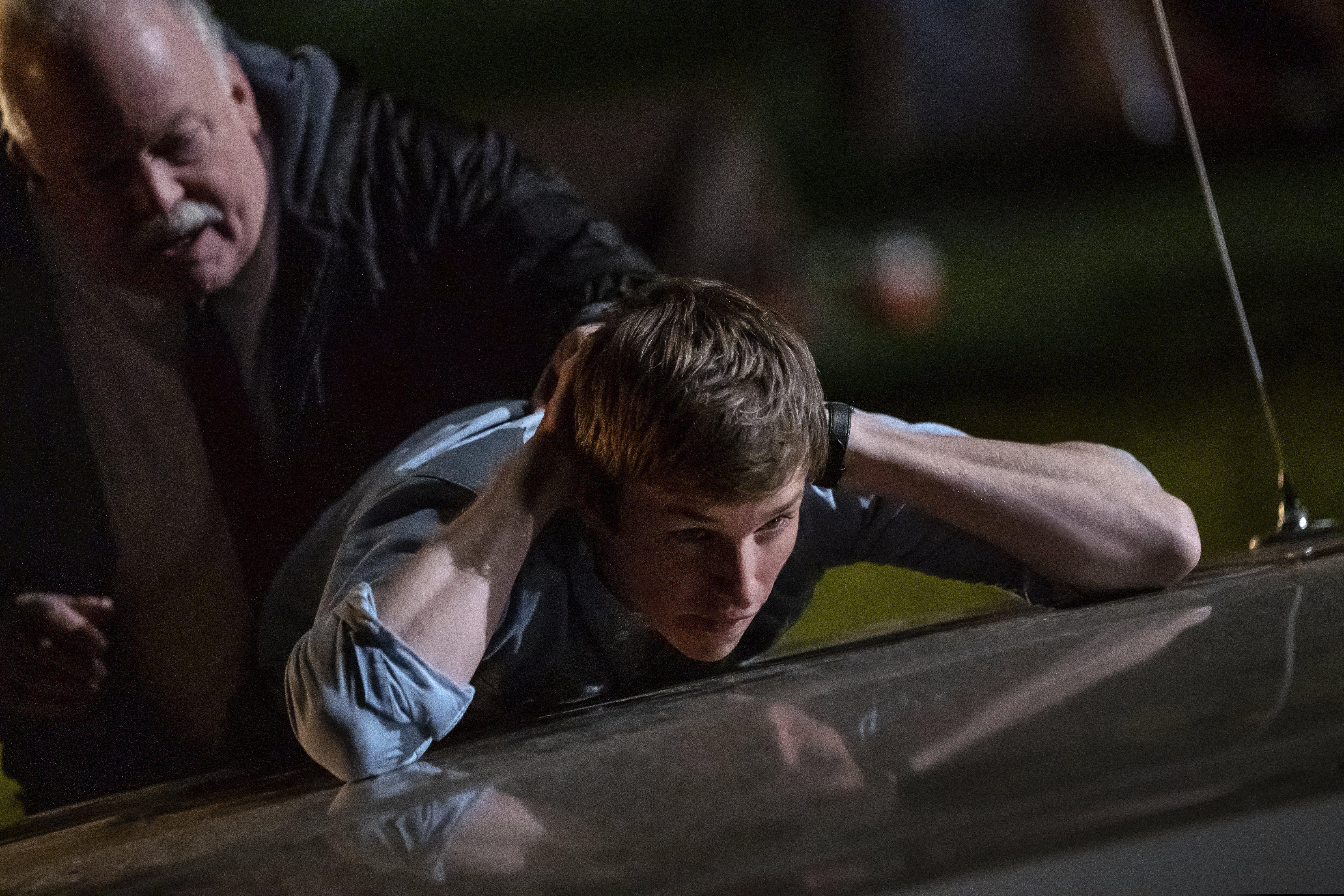 This image released by Netflix shows Eddie Redmayne as Tom Hayden in a scene from "The Trial of the Chicago 7."