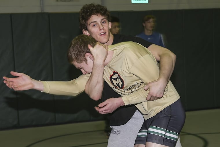 Pennridge wrestler Josh Stillings (rear) works on drills with teammate Christian Perrine. Stillings won in the quarterfinals on Friday.