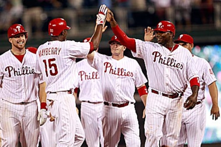 The Phillies celebrate John Mayberry Jr.'s walk-off single. (Yong Kim/Staff Photographer)