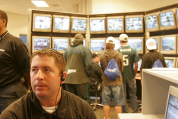 Power sources: Above, Herb Keyser, electrical foreman, monitors use during the Eagles' game with the Redskins. At left, owners Jeffrey Lurie and Christina Weiss Lurie; she is in charge of the team's ecological planning.