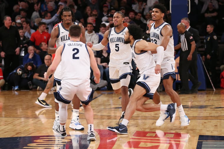 Teammates run towards Brandon Slater, left of Villanova at the conclusion of their 1 point victory over St.John's. Slater hit the game-winning free throws to give Villanova a victory in a Big East Tournament quarterfinal game on March 10, 2022 at Madison Square Garden in New York City.