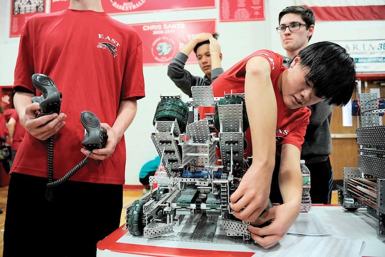 Jesse Wu, a junior at Cherry Hill High School East, made an adjustment to the Galactic Gorillas’ robot before the team sent it out to compete Sunday in the VEX robotics tournament at Cherry Hill East.