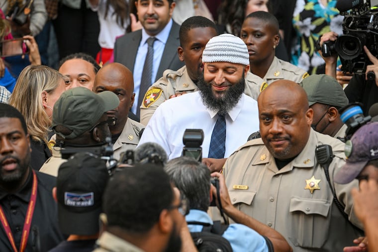 Adnan Syed, center, exits court a free man on Monday.