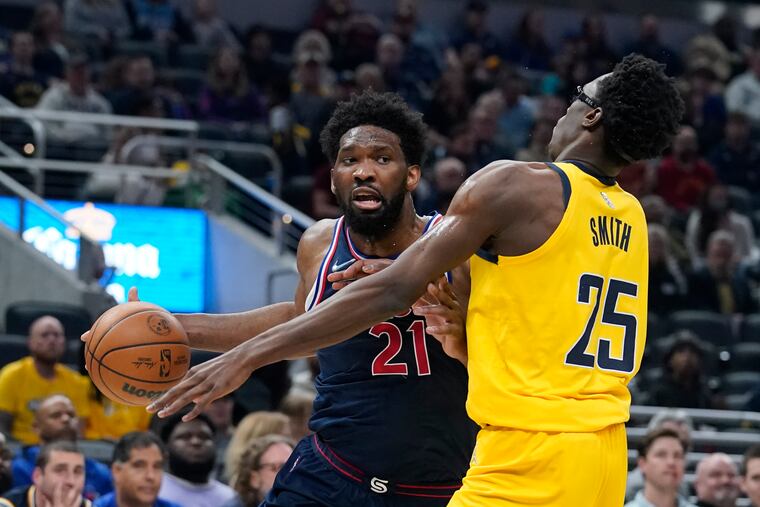The 76ers' Joel Embiid goes to the basket against Indiana's Jalen Smith during the first half in Indianapolis.