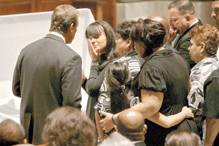 Jazmin Nazario, 15, weeps at the casket of her mother Officer Isabel Nazario. (DAVID SWANSON/Inquirer)