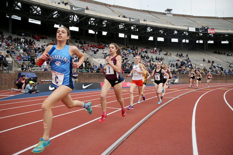 Runners compete in the high school girls' distance medley championship during the 125th annual Penn Relays at Franklin Field in Philadelphia on Thursday, April 25, 2019. Fayetteville-Manlius (Manlius, N.Y.) won the event.
