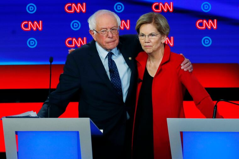 FILE - In this July 30, 2019 file photo, Sen. Bernie Sanders, I-Vt., and Sen. Elizabeth Warren, D-Mass., embrace after the first of two Democratic presidential primary debates hosted by CNN in the Fox Theatre in Detroit.