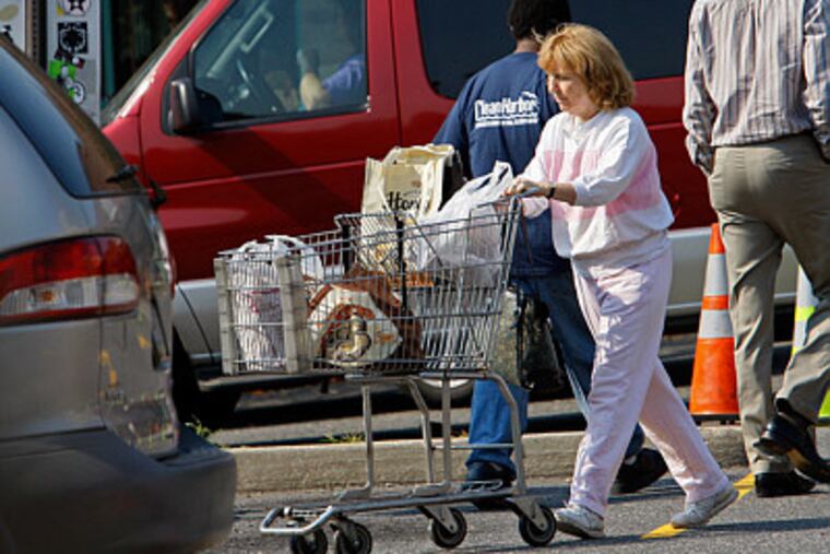 A shopper navigating the congested parking lot at the Whole Foods Market on Callowhill Street. The planned flagship would replace the Callowhill store.