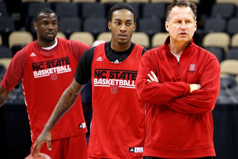 ASSOCIATED PRESS NC State coach Mark Gottfried watches practice as Desmond Lee (left) and Anthony Barber (center) wait their turns to run a drill in preparation for game against Villanova.