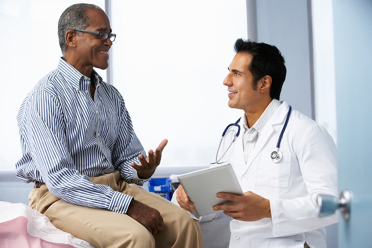 A primary care doctor listens to a patient.