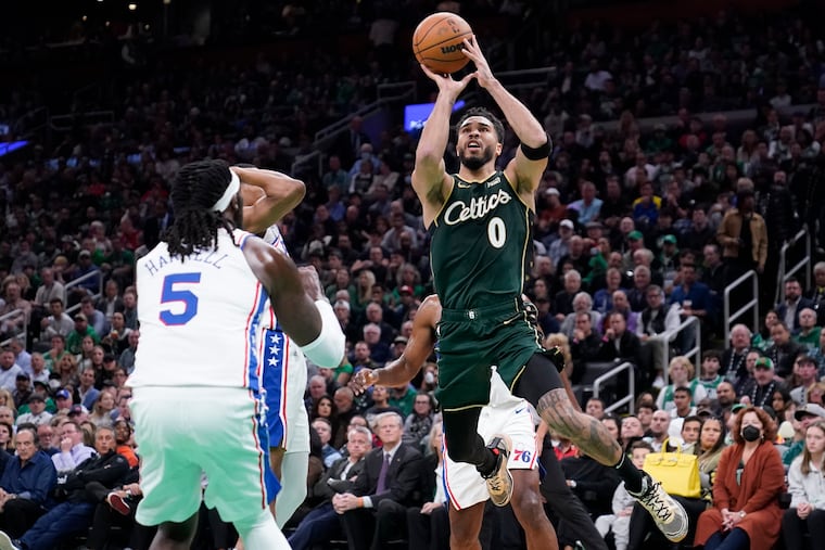 Boston Celtics forward Jayson Tatum shoots over 76ers center Montrezl Harrell during the first half Tuesday.