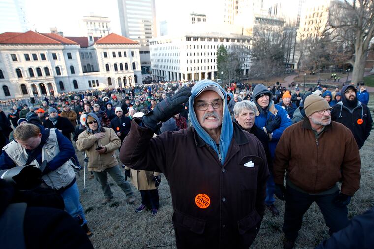 Demonstrators stand on the capitol grounds ahead of a pro gun rally, Monday, Jan. 20, 2020, in Richmond, Va.