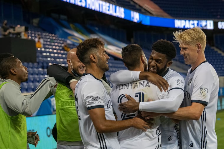 Anthony Fontana (21) gets a hug from Mark McKenzie and celebrates with other teammates after scoring a goal in the Union's 4-1 win over the Montreal Impact on Sunday.