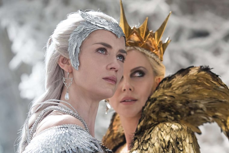 Emily Blunt is Freya, Her Frosty Majesty, and Charlize Theron (right) is Ravenna, her evil sister, in "The Huntsman: Winter's War."