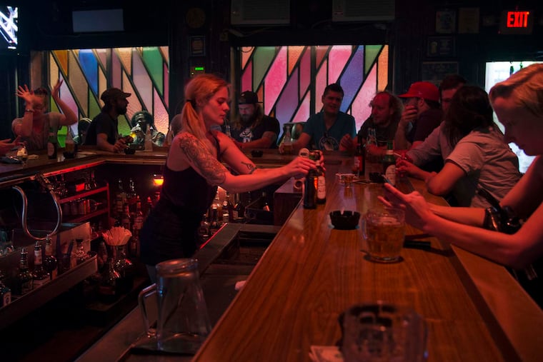 Bartender Ren serves drinks at McGlinchey's, a Philadelphia establishment owned by the same family since 1952.