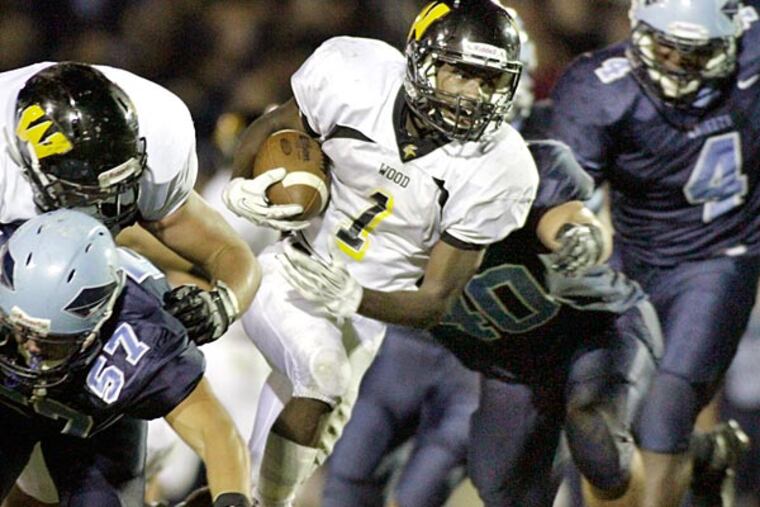 Archbishop Wood's Jarrett McClenton has a big gain on this second
quarter run before being brought down by North Penn's Luke Berry
during the Archbishop Wood at North Pennfootball game on
September 6, 2013. (Elizabeth Robertson/Staff Photographer)