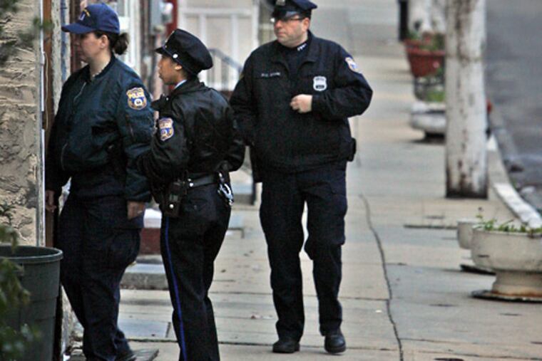 Philadelphia police investigate an alleged homicide on Collom Street in the Germantown section of Philadelphia on Monday morning.
