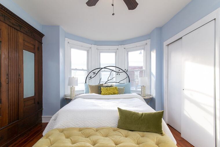 The master bedroom has a built-in armoire, part of the historic charm of the rowhouse.