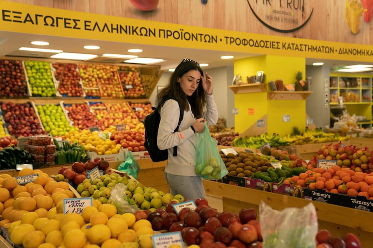 A woman shops at a grocery store in Athens, Greece, in 2022.