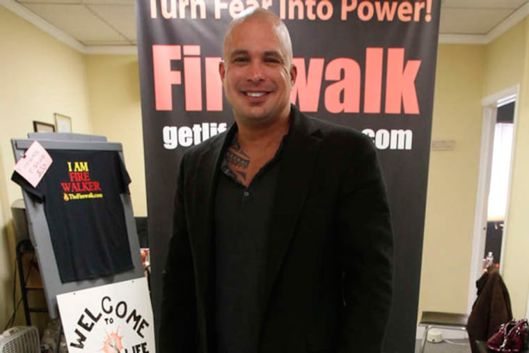 Joe White walks barefoot on glass, a technique he uses with his clients.