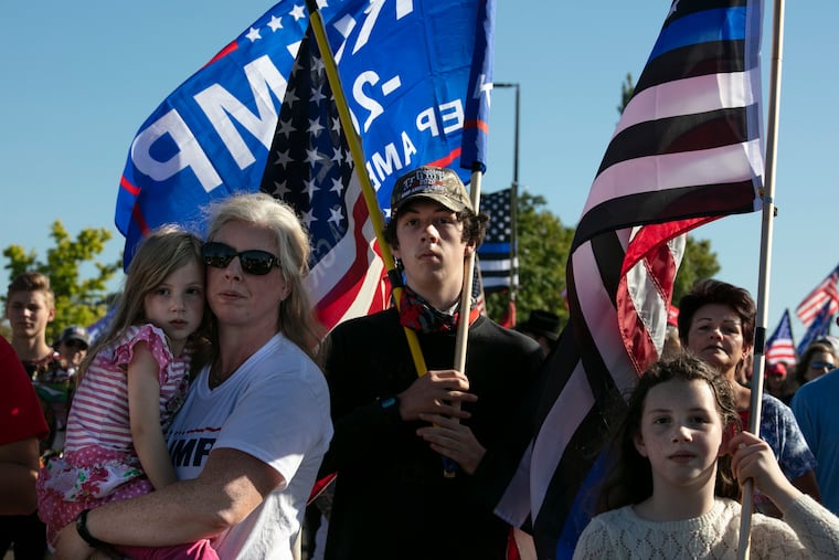 Supporters of President Donald Trump listen to speeches at a rally before a car parade, Saturday, Aug, 29, 2020, in Clackamas, Ore. (AP Photo/Paula Bronstein)