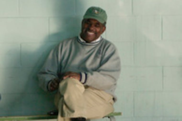 Jim Ellis, keeping an eye on the swimmers during Saturday-morning practice at the Marcus Foster Recreation Center, where he has trained swimming champions. Virtually all of his top swimmers have gone to college on scholarships.