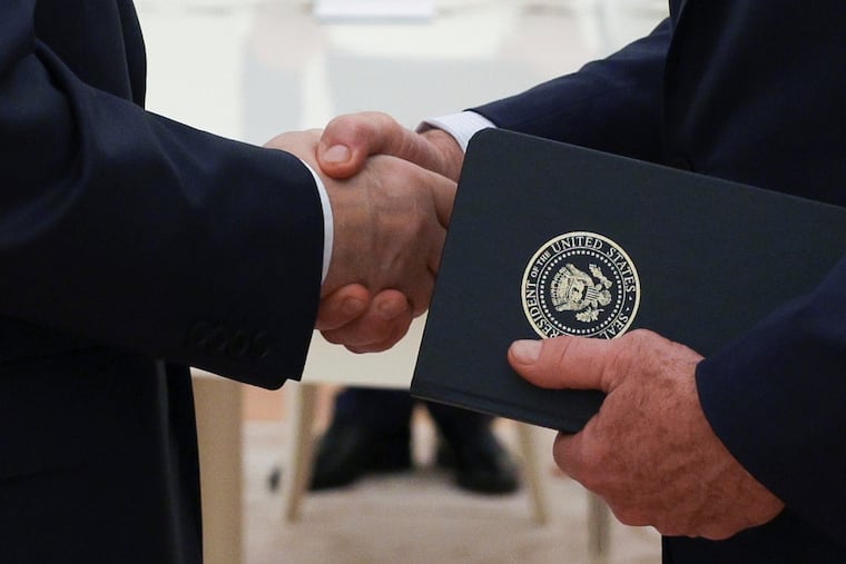 Russian President Vladimir Putin and U.S. President Donald Trump's special envoy Steve Witkoff shake hands during their meeting at the Kremlin, in Moscow, on Aug. 6, 2025.
