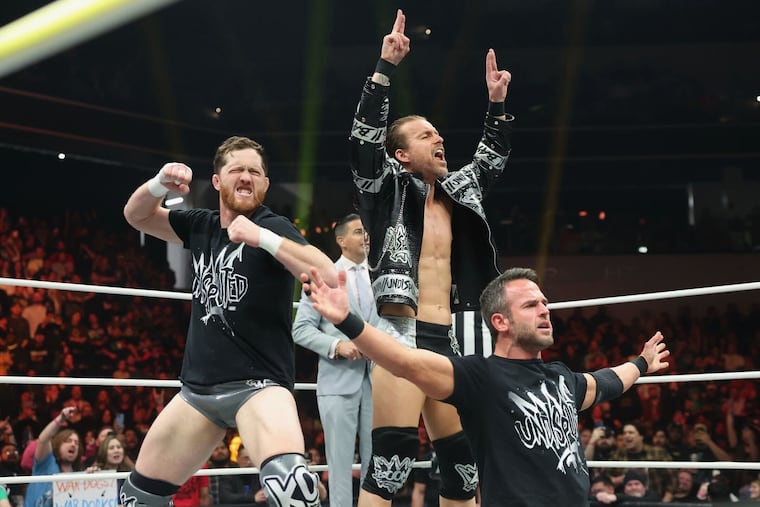 Adam Cole, center, with Kyle O'Reilly and Roderick Strong on February 26 at AEW Dynamite in Oceanside, Calif.