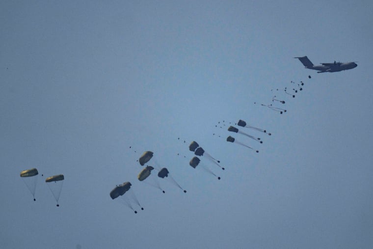 An aircraft airdrops humanitarian aid over Gaza the northern Gaza Strip, as seen from southern Israel, Friday.