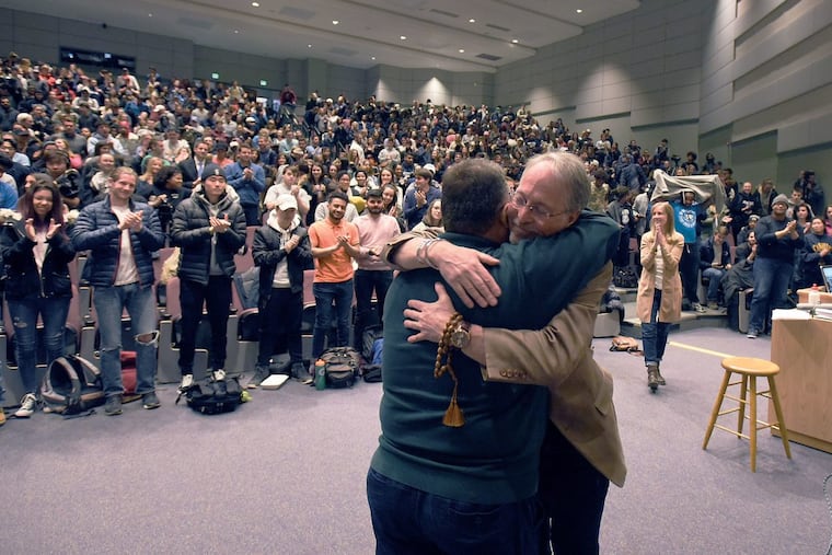 Basim Razzo, left, and Sam Richards hug after Razzo spoke to Richards’ class at Penn State University.