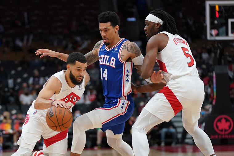 Toronto Raptors guard Fred VanVleet (left) moves around 76ers forward Danny Green (14) as teammate Precious Achiuwa (5) sets a pick during Monday's game.