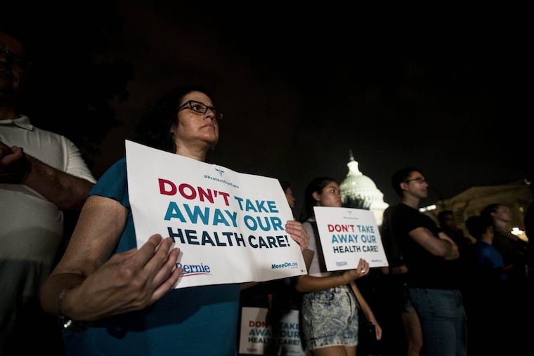 Sandra Hernandez holds a protest sign outside the U.S. Capitol as the Senate votes on a failed effort to repeal the Affordable Care Act in July.