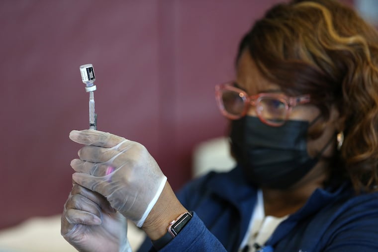Registered nurse Melly Warren extracts the COVID-19 vaccine out of a vial at Tabernacle Baptist Church in Burlington, N.J. on March 21, 2021.