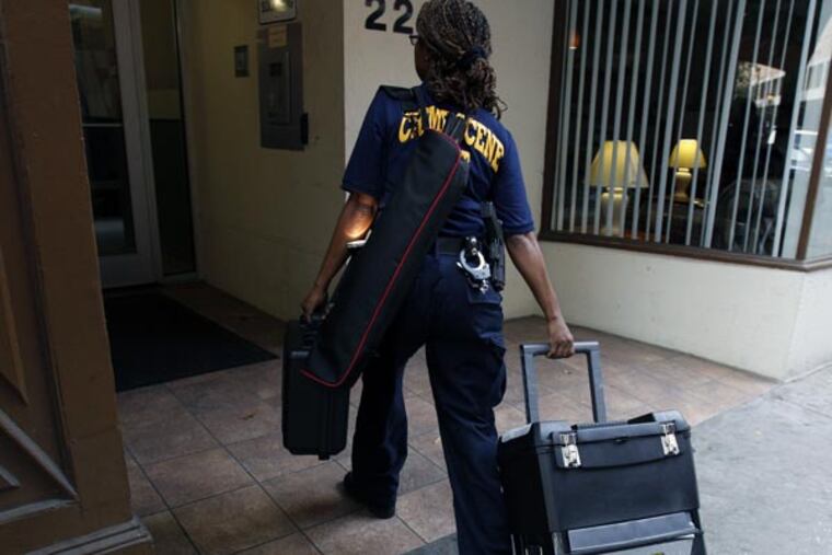 A Philadelphia Crime Scene officer arrives at the Washington Square West building in Philadelphia on September 5, 2013. (DAVID MAIALETTI / Staff Photographer)