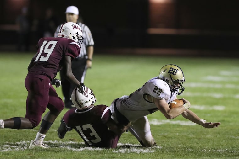 Council Rock Souths Chase Patterson (22) picks up yardage before being tackled by Abington's Jordan Grimaldi (13).