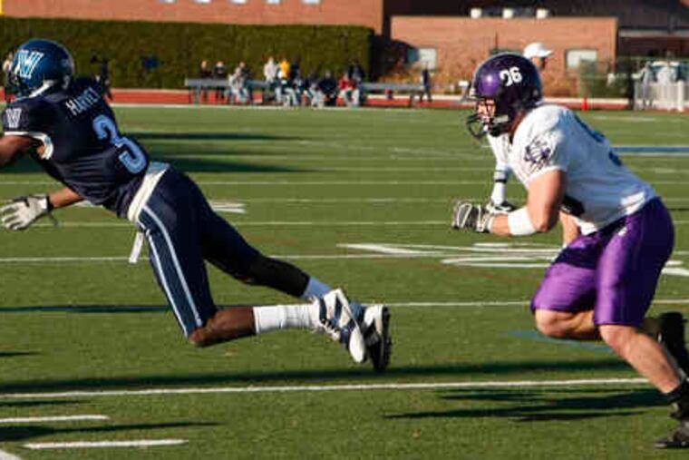 Wildcats wide receiver Brandyn Harvey makes a one-handed catch in front of the Crusaders' Anthony Campbell.