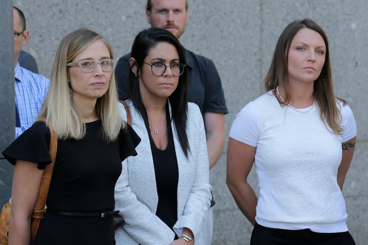 Annie Farmer, left, and Courtney Wild, right, accusers of Jeffery Epstein, stand with an attorney's assistant (center) outside the courthouse in New York, Monday, July 15, 2019. Financier Jeffrey Epstein was found dead in his jail cell on Saturday, August 10, 2019.