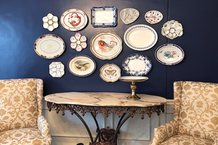 You don't need to limit your art by size: Create your own. Try using antique plates and platters as a wall display, which add texture and depth.