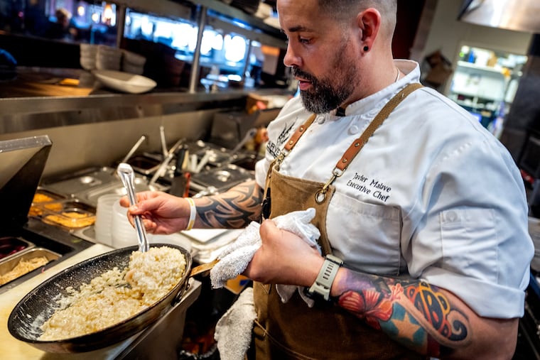 Chef Javier Malave cooking shrimp and scallop risotto at Harvest Seasonal Grill in Moorestown Mall.