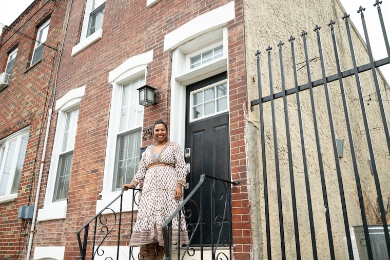 Sindhu Nair poses for a portrait in front of her home in the Port Richmond neighborhood of Philadelphia on Tuesday, Nov. 25, 2025. Nair bought the 3-bedroom rowhome in .August of 2025.