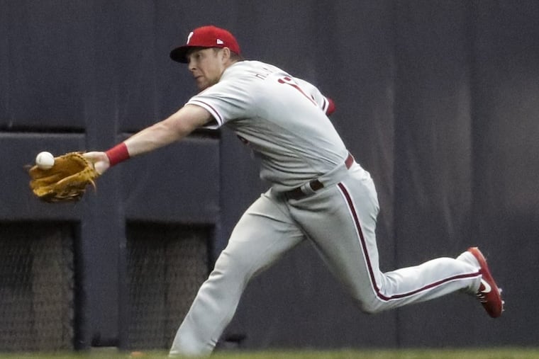 Phillies left fielder Rhys Hoskins can't make the catch in a blowout loss marred by defensive mistakes.
