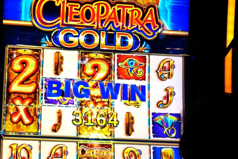 A gambler rings up a win on a slot machine at the Hard Rock casino in Atlantic City, N.J., in August.